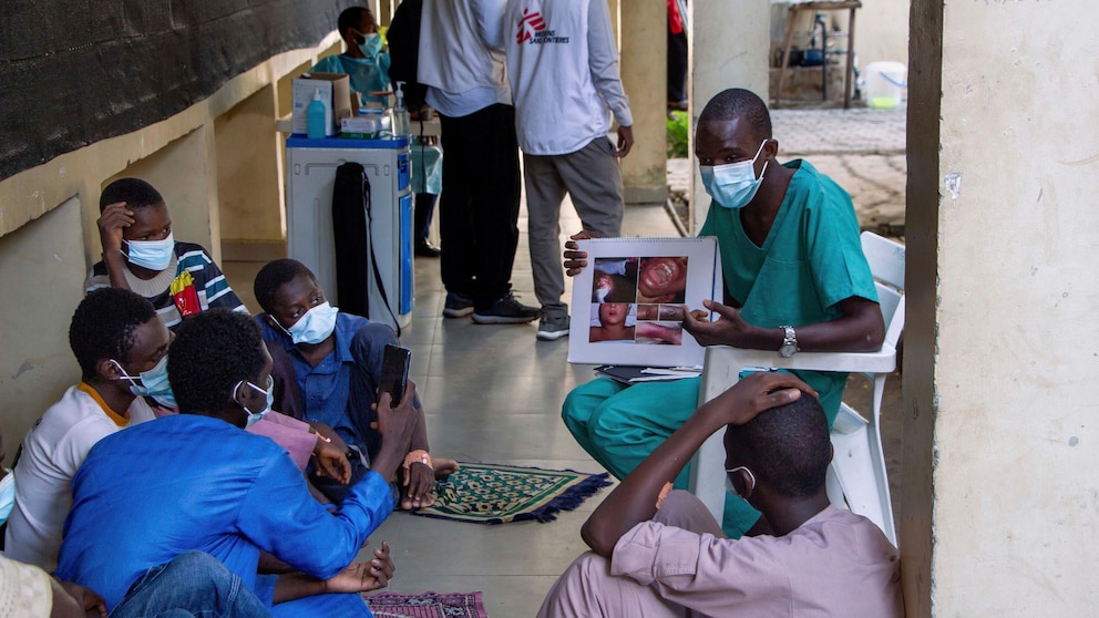 In this handout photo released by MSF, a health worker educating a group of male patients and care givers on the symptoms of Diphtheria at the Murtala muhammad specialist hospital in Kano, Nigeria Monday, Aug. 21, 2023. Authorities in several West African countries are trying to manage their huge diphtheria outbreaks, including in Nigeria where a top health official said Thursday Nov. 23, 2023 that millions are being vaccinated to cover wide gaps in immunity against the disease. (Ehab Zawati, MSF via AP)